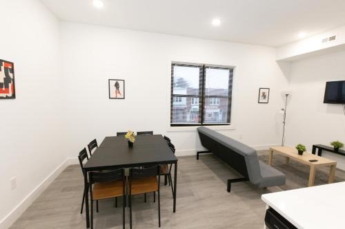 a living room with a table and chairs and a couch at Modern Contemporary 2-Bed Apt Close to NYC in Bayonne