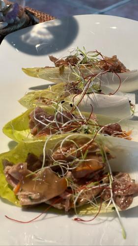 a plate of food with meat and vegetables on it at Hospedería SANTA FE in Epároz