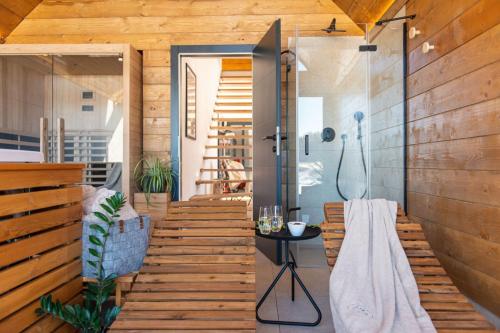 a bathroom with wooden stairs and a shower in a house at Villa Bellis in Mrkopalj