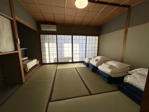 Una cama o camas en una habitación de 高島市安曇川町琵琶湖徒歩3分エクシブ 高島 近くBbQ自転車無料貸出
