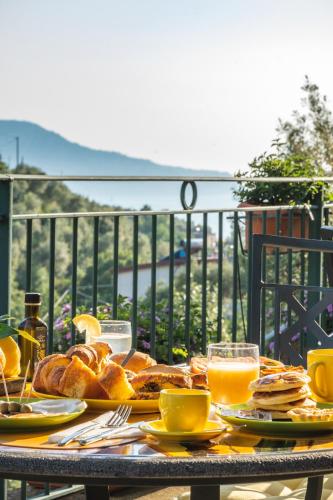 a table with bread and orange juice on a balcony at Oleum in Massa Lubrense
