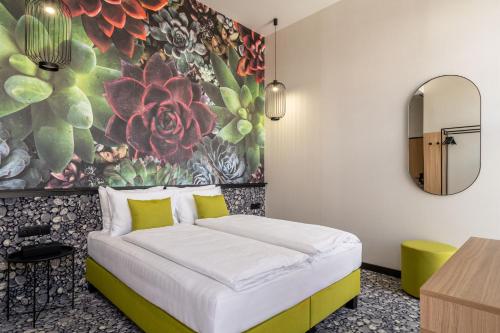 a bedroom with a bed with a floral wall at URBAN HOTEL in Debrecen