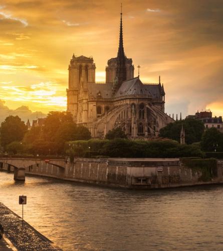 a large building with a bridge in front of a river at Appartement Quartier Latin in Paris