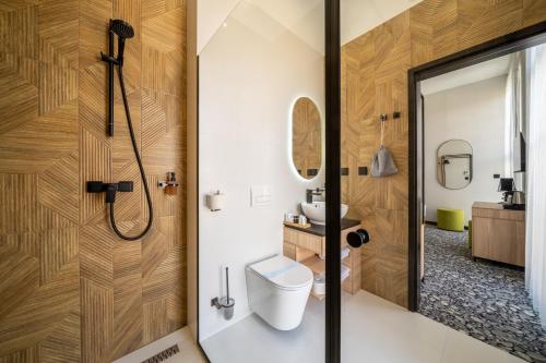 a bathroom with a toilet and a shower at URBAN HOTEL in Debrecen
