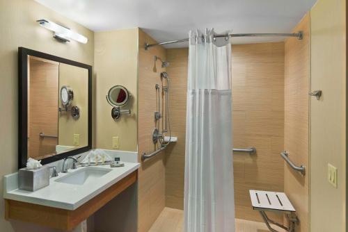 a bathroom with a sink and a shower at DoubleTree by Hilton San Pedro in San Pedro