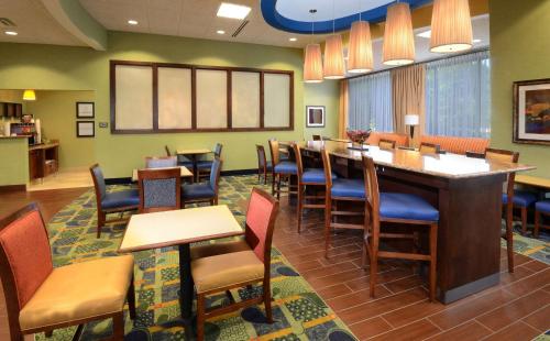a waiting room with a long table and chairs at Hampton Inn Roxboro in Roxboro