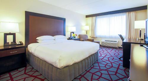 a hotel room with a large bed and a large window at DoubleTree by Hilton Chicago/Alsip in Alsip