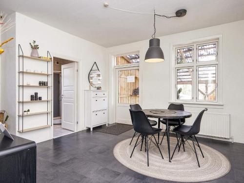 a kitchen and dining room with a table and chairs at 5 star holiday home in Grindsted-By Traum in Grindsted