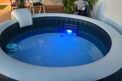 a large blue bath tub in a room at Apartamento con terraza y jacuzzi, zona ciutadella in Cala en Blanes