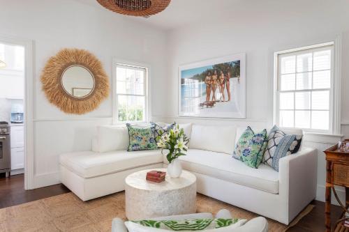 ein Wohnzimmer mit einer weißen Couch und einem Tisch in der Unterkunft Blue Cottage at Casa Zoe in Charleston