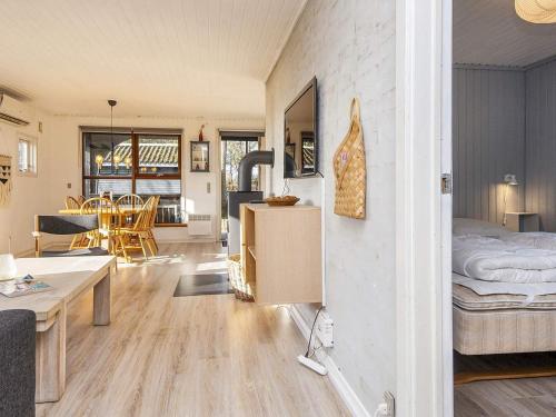 a room with a bed and a dining room at 5 person holiday home in Ansager-By Traum in Ansager