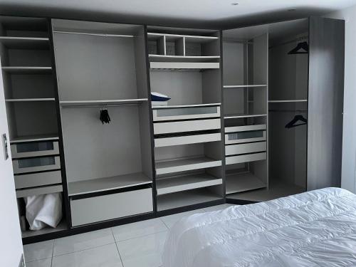 a bedroom with gray shelves and a bed at Magnifique villa avec piscine chauffée in Cauroy-lès-Hermonville