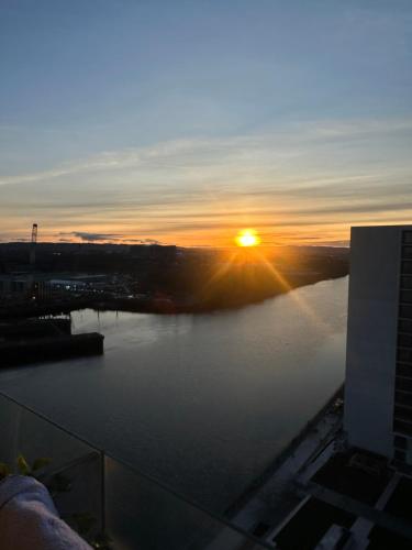 a view of a sunset over a river at Water view harbour in Glasgow