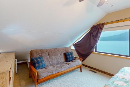 a couch in a room with a large window at On the Shoreline in Cocolalla