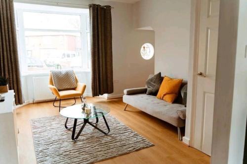 a living room with a couch and a table at Home from Home in Tyne and Wear in Westoe