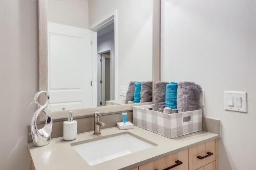 a bathroom with a sink and a mirror at Modern getaway minutes from Truist park! in Atlanta