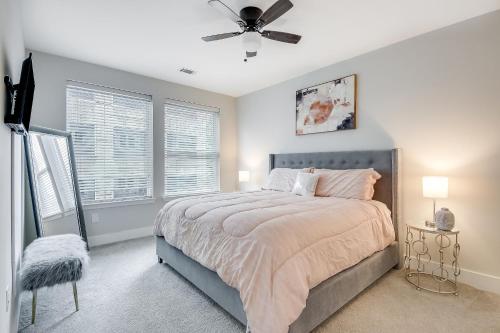 a bedroom with a bed and a ceiling fan at Modern getaway minutes from Truist park! in Atlanta