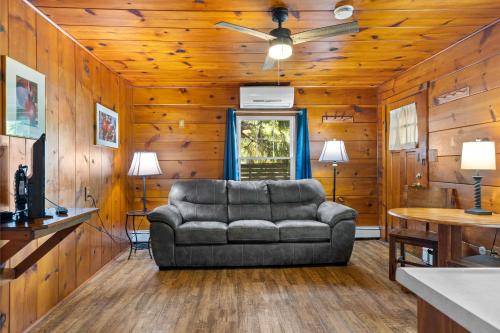 a living room with a couch and a ceiling fan at Lakeview on the Lake in North East