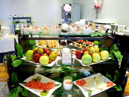 a buffet line with different types of fruits and vegetables at Best Western Plus The Hub Hotel in Milan