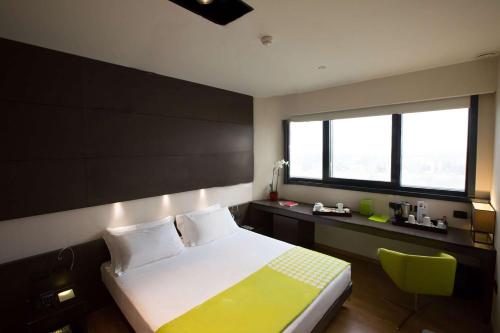 a hotel room with a bed and a window at Best Western Plus The Hub Hotel in Milan