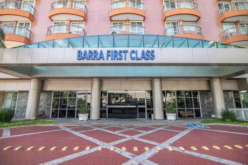 a building with a sign that reads barbara first class at Flat Barra First in Rio de Janeiro