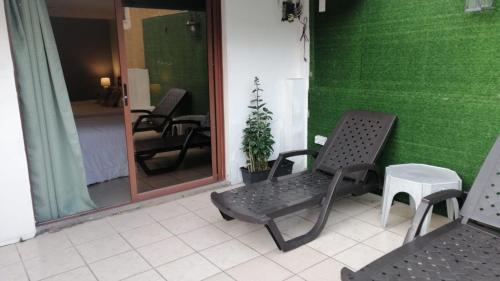 a room with two chairs and a green wall at HOTEL VIEILLE MAISON in Quito