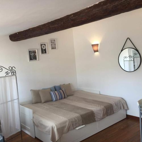 a bedroom with a bed with a mirror on the wall at Appartement rue d'Italie in Aix-en-Provence