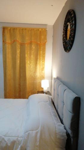 a bedroom with a bed and a window with a lamp at HOTEL VIEILLE MAISON in Quito