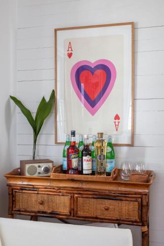 a table with drinks and a picture of a heart at Green Cottage at Casa Zoe in Charleston