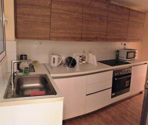 a small kitchen with a sink and a microwave at Kolonaki Private Room in Athens