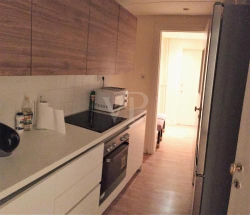 a kitchen with a counter top with a microwave at Kolonaki Private Rooms in Athens