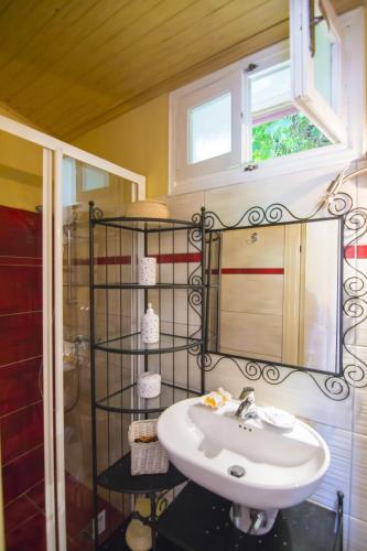 a bathroom with a sink and a window at Yiannas Studio in Gaios