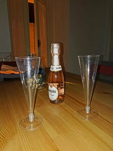 two empty glasses and a bottle of beer on a table at Adalù apartments in Conversano