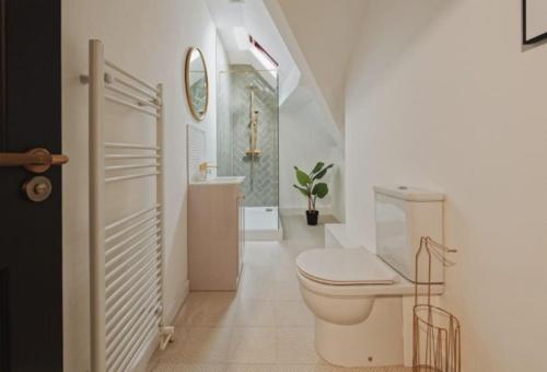 a white bathroom with a toilet and a sink at Lamara Flat 3, Liverpool in Liverpool