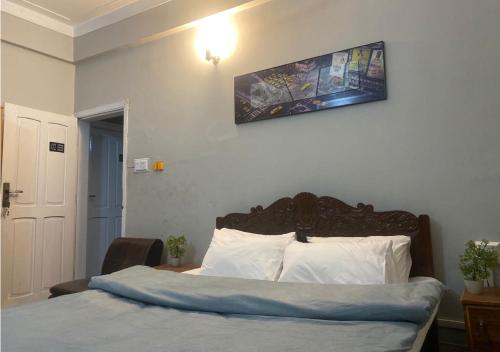 1 dormitorio con 1 cama con una foto en la pared en Outdoor Adventures Resort en Muzaffarabad