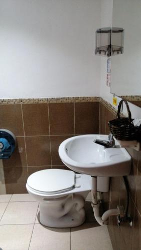 a bathroom with a toilet and a sink at HOTEL VIEILLE MAISON in Quito