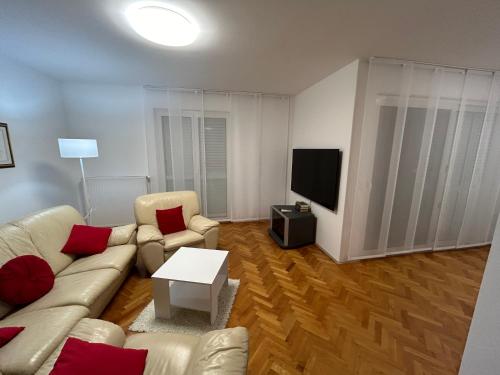 a living room with a couch and a tv at Apartment Tina in Rijeka