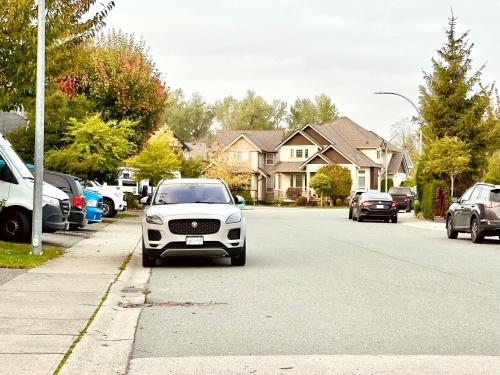 a white car parked on the side of a street at Scorpion Hiuse Langley -ROOM 1 Separate restroom in Pitt Meadows