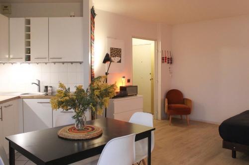 a kitchen and living room with a table and chairs at Charming and practical studio in Paris 14th in Paris