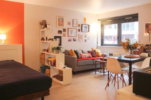 a living room with a couch and a table at Charming and practical studio in Paris 14th in Paris