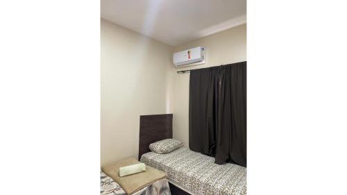 a bedroom with two beds and a tv on the wall at DUNAS RESIDENCE CASA 02 in Santo Amaro