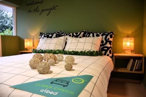 a bedroom with a bed with a sign on it at UrbanJungle-Studio σε ξέφωτο μες στην πόλη in Patra