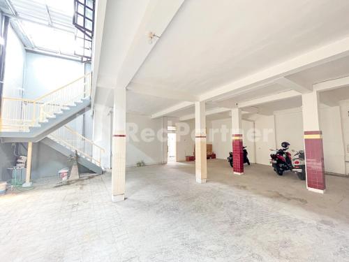 an empty room with a staircase in a building at Homestay & Cafe Blessings Near Station Center Town RedPartner in Kediri