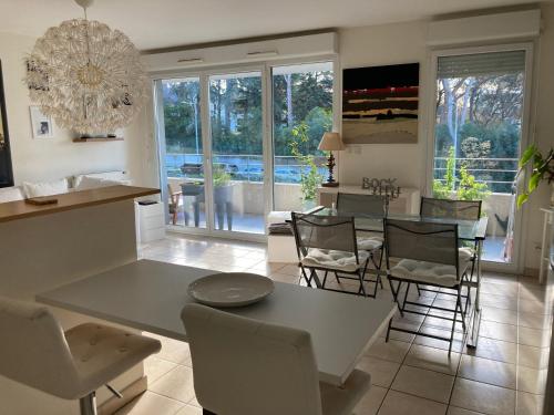 une cuisine et une salle à manger avec une table et des chaises dans l'établissement T2 élégant, à Montpellier