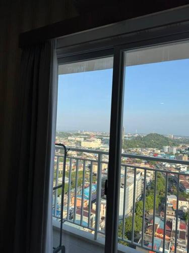 a window in a room with a view of a city at CitraPlaza Nagoya #32 cozy (WI-Fi) in Jodoh