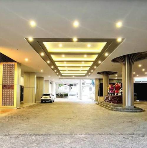 a parking lot with a car parked in a building at CitraPlaza Nagoya #32 cozy (WI-Fi) in Jodoh
