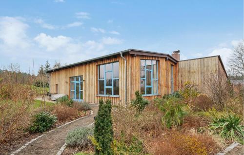a wooden house in the middle of a garden at Stunning Home In Templin With Sauna in Templin