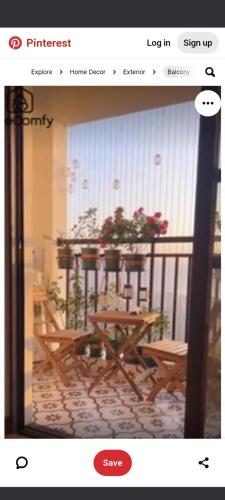 a picture of a balcony with a table with flowers at Any short or long term stay in Dhaka
