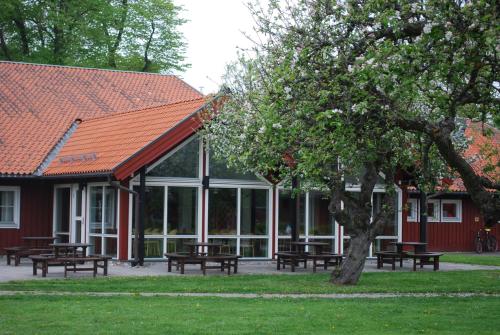 a group of picnic tables in front of a building at Valla Folkhögskola in Linköping