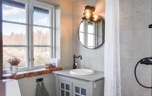 a bathroom with a sink and a window at Stunning Home In Ystad With Kitchen in Ystad